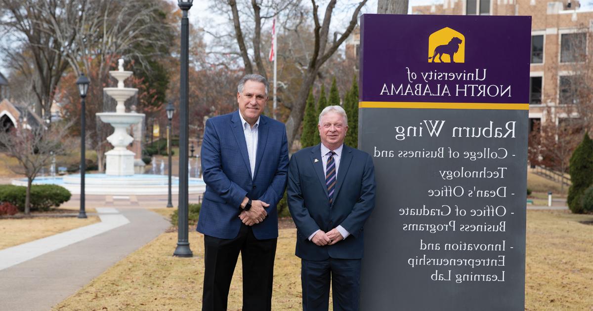 College of Business and Technology Dean Greg Carnes and Lyons HR, LLC Founder Bill Lyons stand in front of the Raburn Wing of Keller Hall on campus at the University of North Alabama.