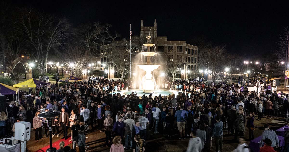 Members of the UNA community celebrate the lighting of Harrison Fountain.